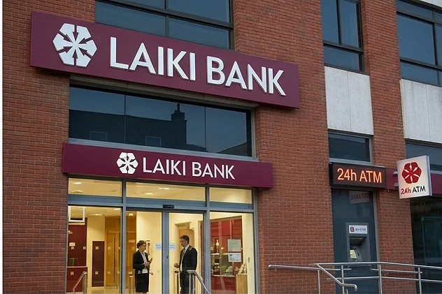 The illuminated entrance of the Laiki Bank UK branch with staff by the door